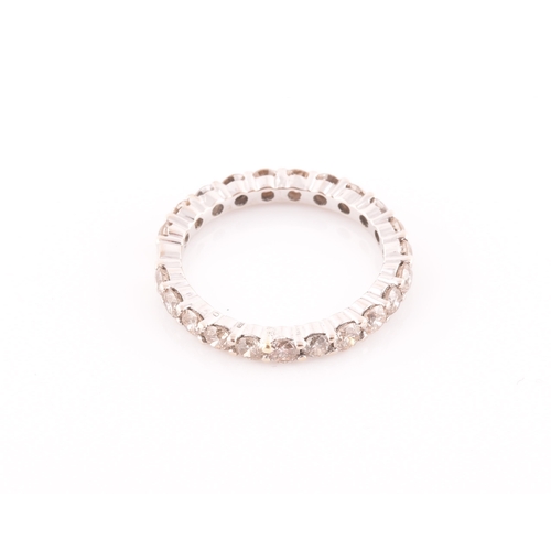 19 - A diamond eternity ring, set with twenty two round brilliant-cut diamonds, of approximately 1.0 cara... 