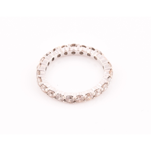 19 - A diamond eternity ring, set with twenty two round brilliant-cut diamonds, of approximately 1.0 cara... 