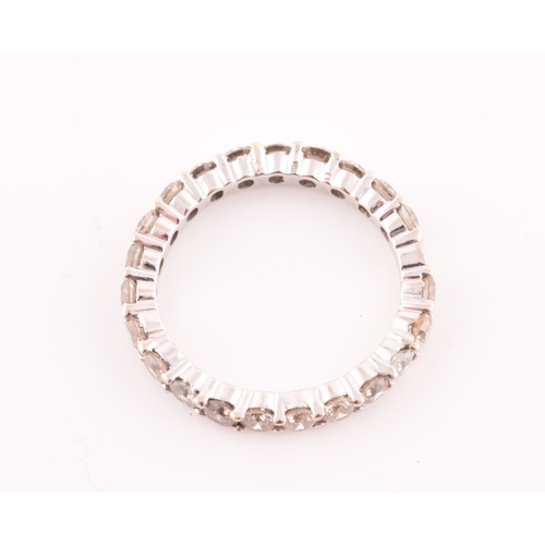 19 - A diamond eternity ring, set with twenty two round brilliant-cut diamonds, of approximately 1.0 cara... 