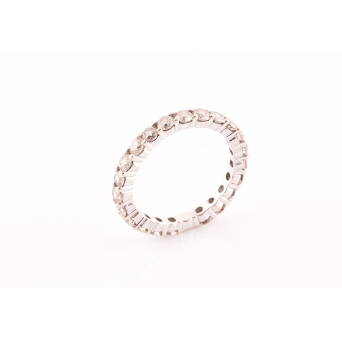 19 - A diamond eternity ring, set with twenty two round brilliant-cut diamonds, of approximately 1.0 cara... 