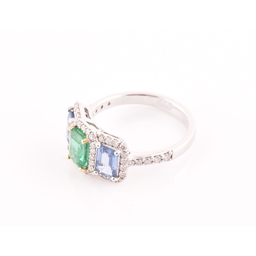 21 - An 18ct white gold, diamond, emerald, and sapphire ring, the triple cluster set with a mixed rectang... 