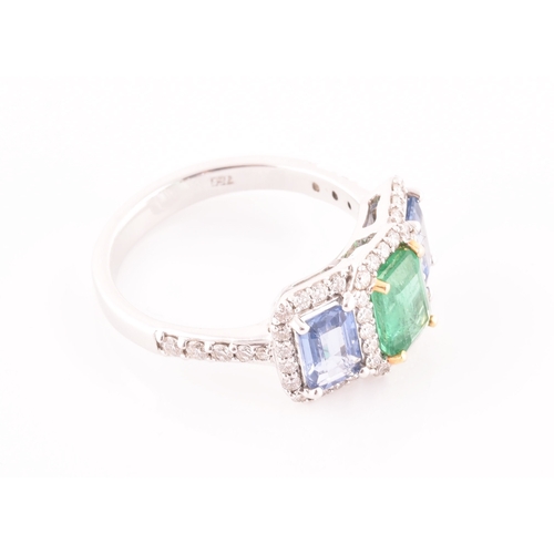 21 - An 18ct white gold, diamond, emerald, and sapphire ring, the triple cluster set with a mixed rectang... 