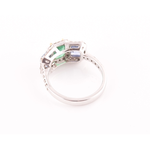 21 - An 18ct white gold, diamond, emerald, and sapphire ring, the triple cluster set with a mixed rectang... 