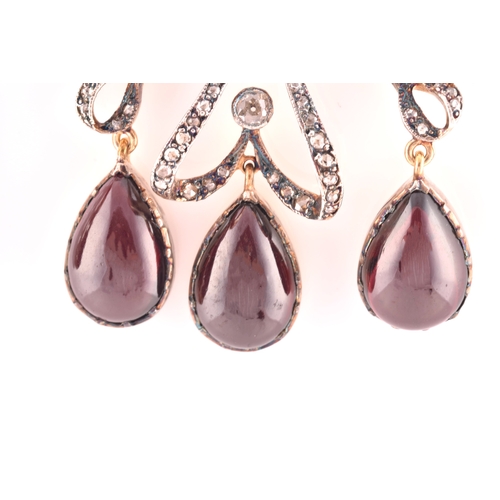 22 - An unusual pair of garnet and diamond earrings, in the Victorian style, set with a round cabochon ga... 