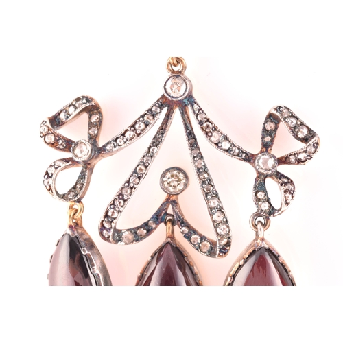 22 - An unusual pair of garnet and diamond earrings, in the Victorian style, set with a round cabochon ga... 