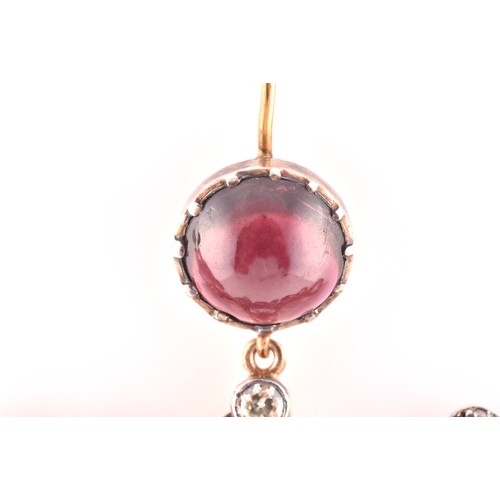 22 - An unusual pair of garnet and diamond earrings, in the Victorian style, set with a round cabochon ga... 