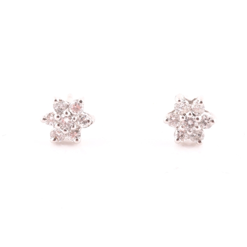 23 - A pair of 18ct white gold and diamond floral cluster earrings, approximately 6 mm diameter.