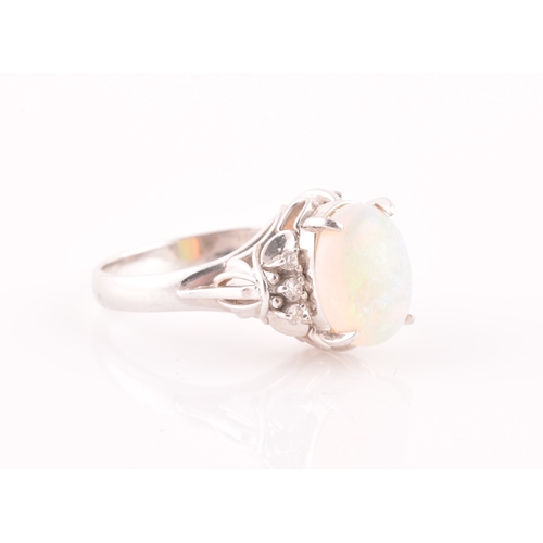 26 - A platinum, diamond, and opal ring, four-claw set with an oval cabochon opal, with three round-cut d... 