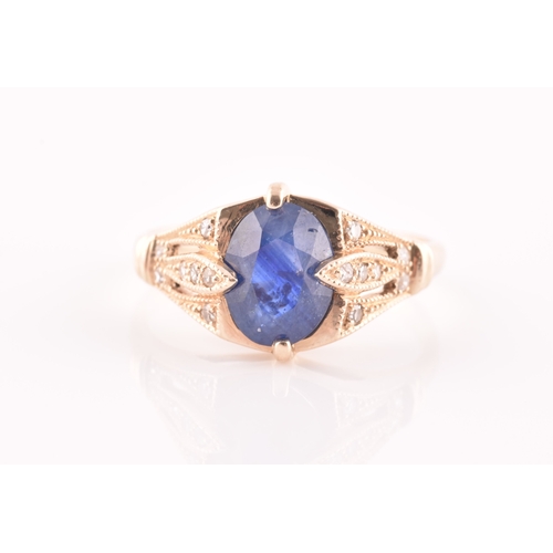 27 - A yellow metal and sapphire ring, set with a mixed oval-cut sapphire, the mount inset with round bri... 