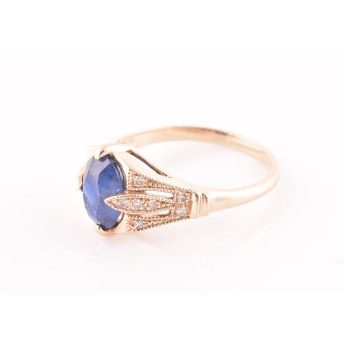 27 - A yellow metal and sapphire ring, set with a mixed oval-cut sapphire, the mount inset with round bri... 