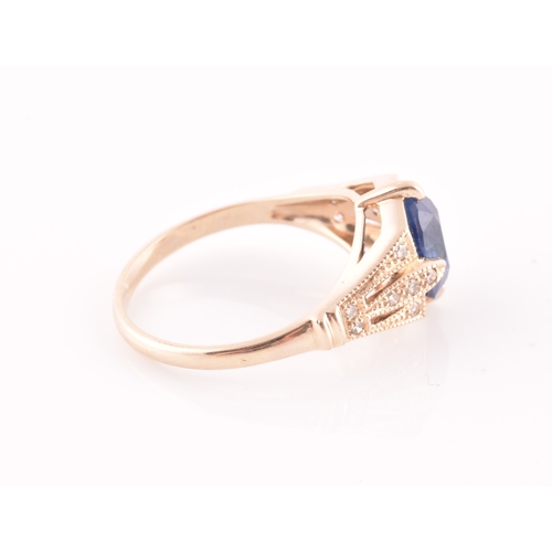 27 - A yellow metal and sapphire ring, set with a mixed oval-cut sapphire, the mount inset with round bri... 