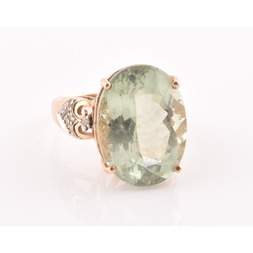 28 - A 9ct yellow gold and green quartz cocktail ring, set with a large mixed oval-cut green stone, with ... 