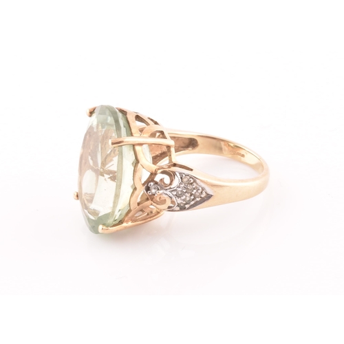 28 - A 9ct yellow gold and green quartz cocktail ring, set with a large mixed oval-cut green stone, with ... 