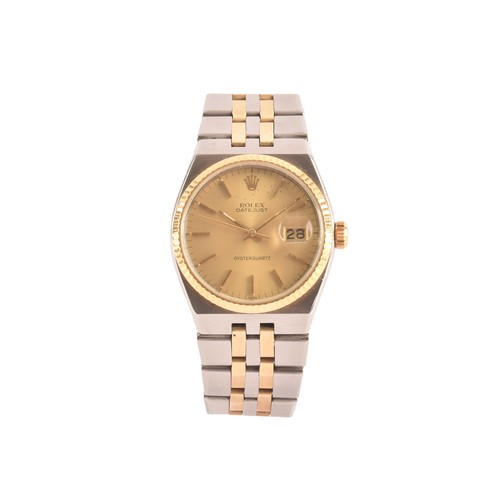 A 1978 Rolex Oyster Quartz Datejust reference 17013, the gilt dial with baton indices and date aperture with cyclops, with gold fluted bezel, on a steel and gold two tone Rolesor bracelet. 17013 stamped to each end link. With Rolex box and travel/service pouch. No paperwork. Serial number 5482775. 36mm case.