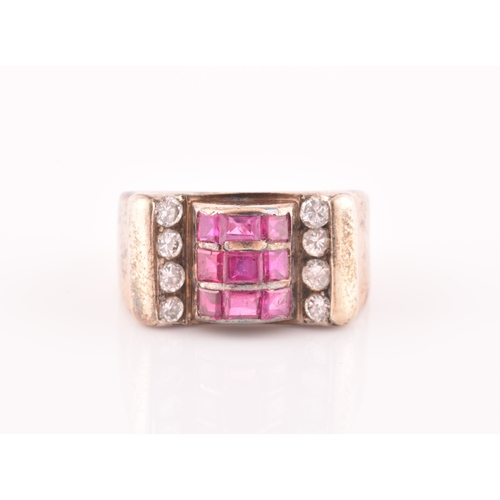 30 - A 1940s ruby and diamond cocktail ring, the raised mount inset with nine mixed square-cut rubies, wi... 