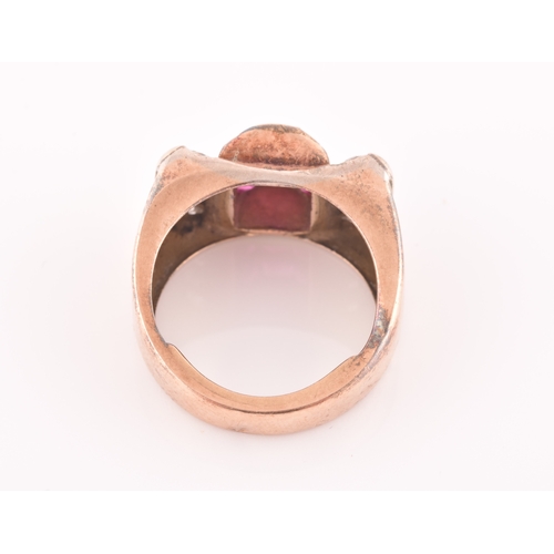 30 - A 1940s ruby and diamond cocktail ring, the raised mount inset with nine mixed square-cut rubies, wi... 