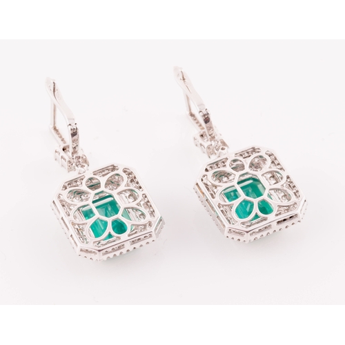 34 - A pair of 18ct white gold, diamond, and emerald pendant drop earrings, each set with a mixed emerald... 