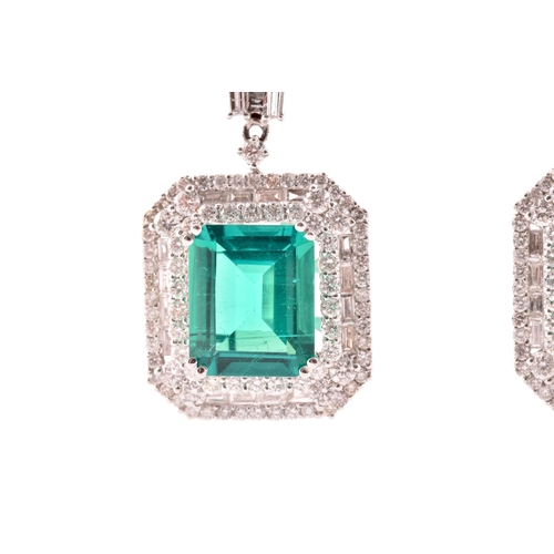 34 - A pair of 18ct white gold, diamond, and emerald pendant drop earrings, each set with a mixed emerald... 