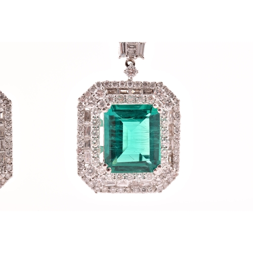 34 - A pair of 18ct white gold, diamond, and emerald pendant drop earrings, each set with a mixed emerald... 