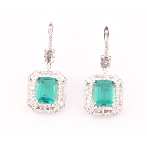 34 - A pair of 18ct white gold, diamond, and emerald pendant drop earrings, each set with a mixed emerald... 