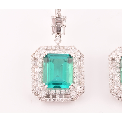 34 - A pair of 18ct white gold, diamond, and emerald pendant drop earrings, each set with a mixed emerald... 