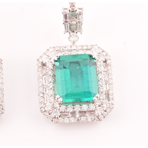 34 - A pair of 18ct white gold, diamond, and emerald pendant drop earrings, each set with a mixed emerald... 