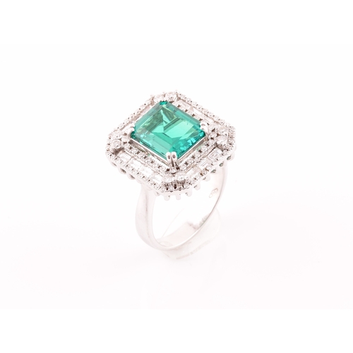 35 - An 18ct white gold, diamond, and emerald cocktail ring, set with a synthetic (hydrothermal) emerald-... 