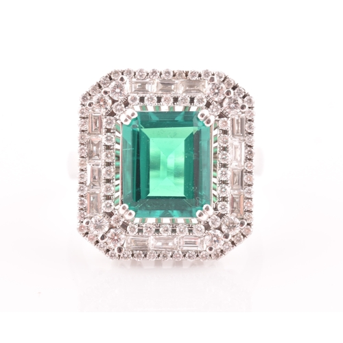 35 - An 18ct white gold, diamond, and emerald cocktail ring, set with a synthetic (hydrothermal) emerald-... 