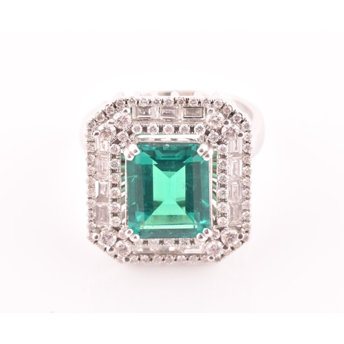 35 - An 18ct white gold, diamond, and emerald cocktail ring, set with a synthetic (hydrothermal) emerald-... 