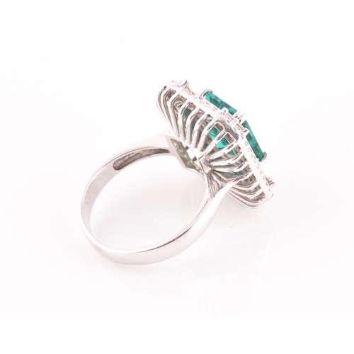 35 - An 18ct white gold, diamond, and emerald cocktail ring, set with a synthetic (hydrothermal) emerald-... 