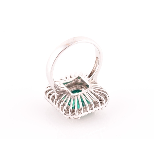 35 - An 18ct white gold, diamond, and emerald cocktail ring, set with a synthetic (hydrothermal) emerald-... 