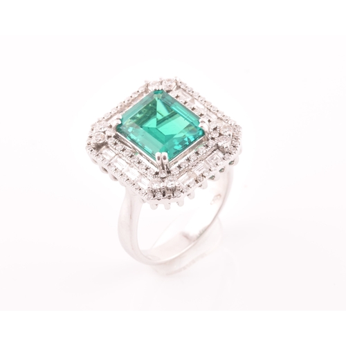 35 - An 18ct white gold, diamond, and emerald cocktail ring, set with a synthetic (hydrothermal) emerald-... 