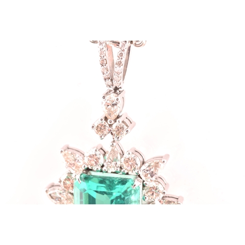 36 - An impressive diamond and emerald drop pendant necklace, set with a (synthetic) hydrothermal emerald... 