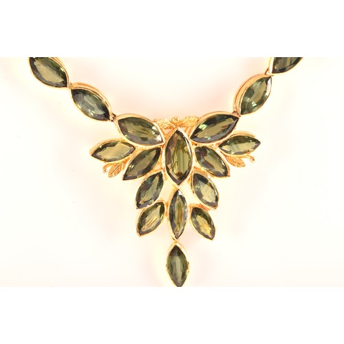 37 - A high carat yellow gold and green sapphire necklace, comprised of bezel-set mixed marquise-cut gree... 