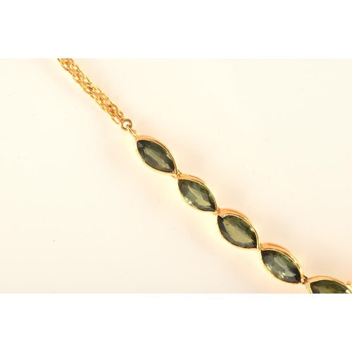 37 - A high carat yellow gold and green sapphire necklace, comprised of bezel-set mixed marquise-cut gree... 