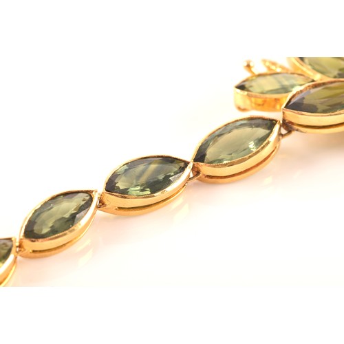 37 - A high carat yellow gold and green sapphire necklace, comprised of bezel-set mixed marquise-cut gree... 