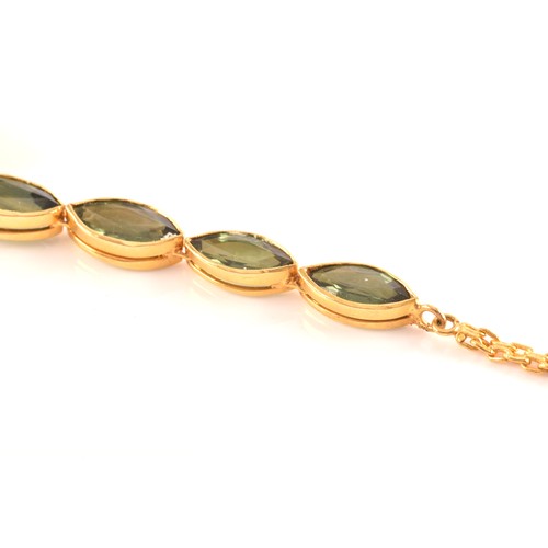 37 - A high carat yellow gold and green sapphire necklace, comprised of bezel-set mixed marquise-cut gree... 