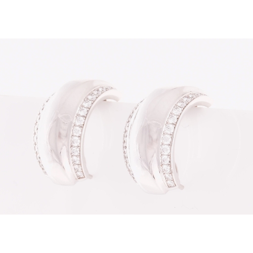 39 - Chopard. A pair of 18ct white gold and diamond earrings, in the La Strada design, the curved half ho... 