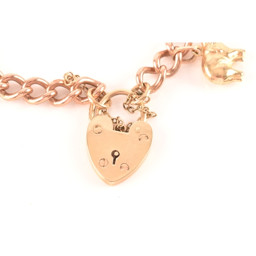 1 - A 9ct rose gold curb link charm bracelet, suspended with a yellow metal teddy bear charm, a yellow m... 