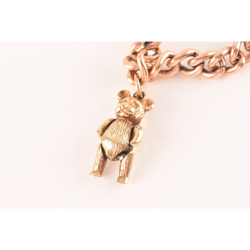 1 - A 9ct rose gold curb link charm bracelet, suspended with a yellow metal teddy bear charm, a yellow m... 