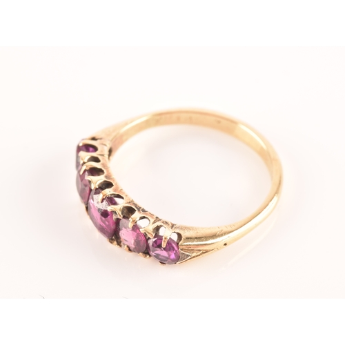 49 - An 18ct yellow gold and purple spinel five stone ring, set with mixed cushion and round-cut spinels,... 