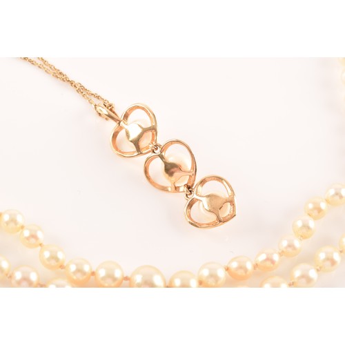 51 - A 14ct yellow gold and pearl pendant, the three heart-shaped segments each set with a white cultured... 