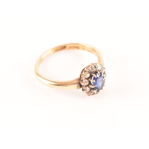 56 - An 18ct yellow gold, diamond, and sapphire cluster ring, set with a mixed oval-cut blue sapphire wit... 