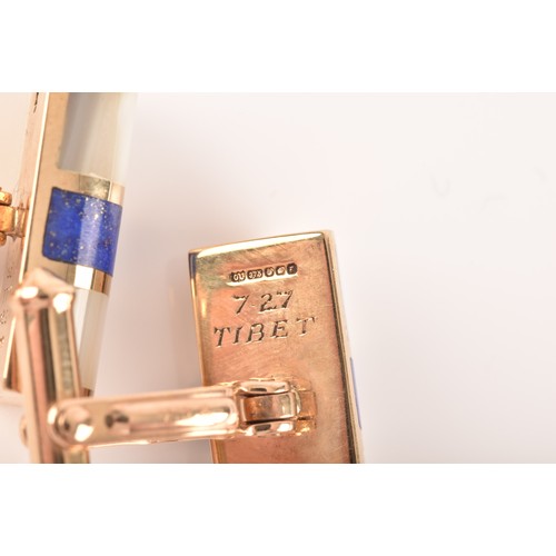 61 - A pair of 9ct yellow gold, lapis lazuli, and mother-of-pearl cufflinks, the smooth batons inlaid wit... 