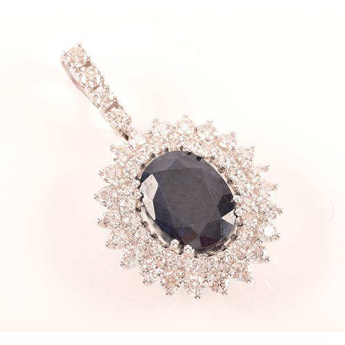 65 - A diamond and sapphire cluster pendant, set with a mixed oval-cut sapphire, measuring approximately ... 