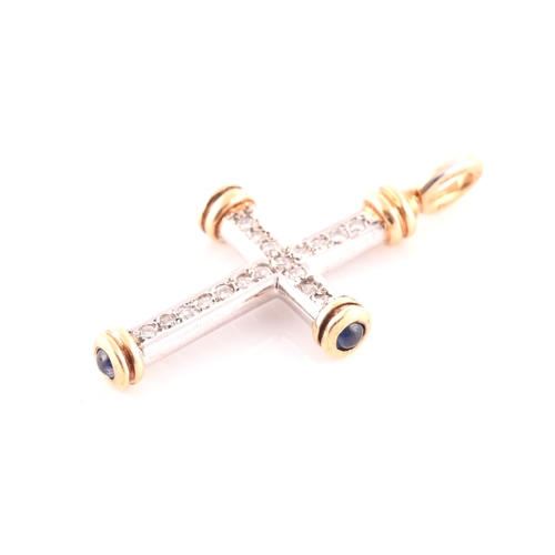 67 - An 18ct gold, diamond, and sapphire cross, the white gold cross mount inset with round brilliant-cut... 