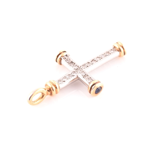 67 - An 18ct gold, diamond, and sapphire cross, the white gold cross mount inset with round brilliant-cut... 