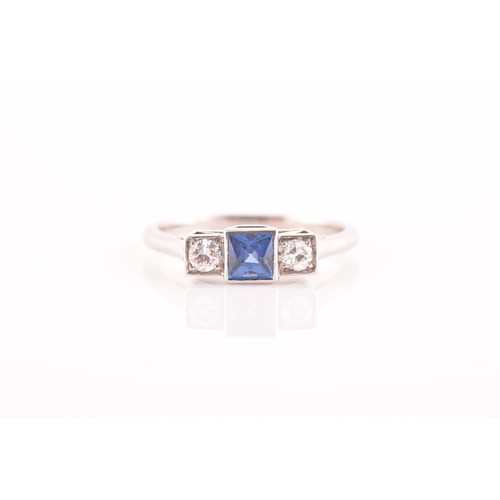 68 - A diamond and sapphire ring, set with a fancy square-cut sapphire, flanked with two round brilliant-... 