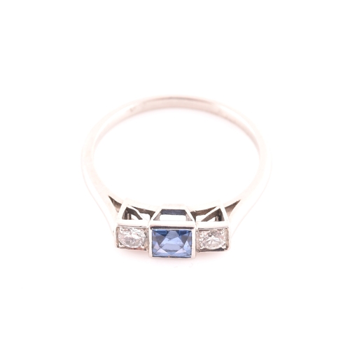 68 - A diamond and sapphire ring, set with a fancy square-cut sapphire, flanked with two round brilliant-... 