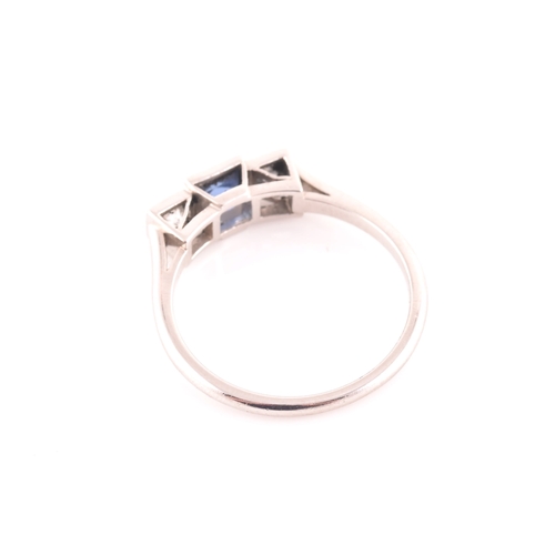 68 - A diamond and sapphire ring, set with a fancy square-cut sapphire, flanked with two round brilliant-... 